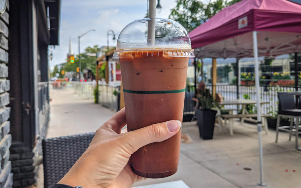 Hand Holding Iced Coffee on a Patio in Downtown St Catharines