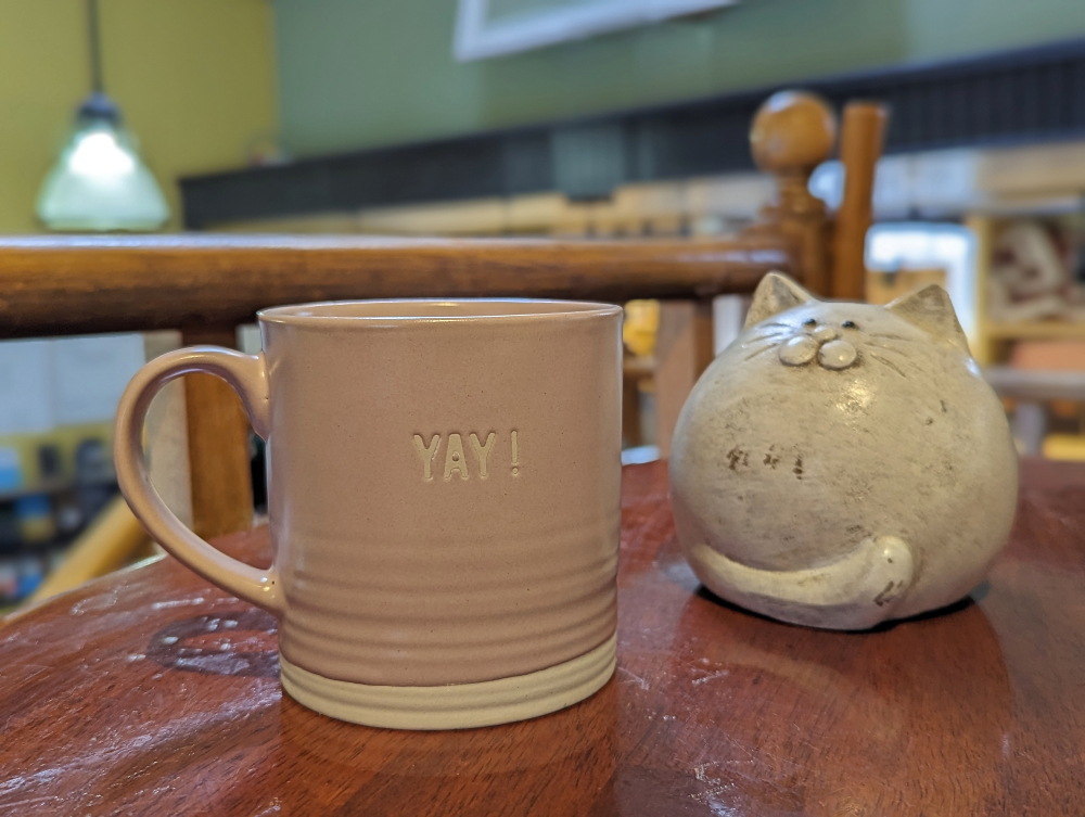 coffee cup and cat figurine at It's The Cat's Meow Cafe in Markham Village