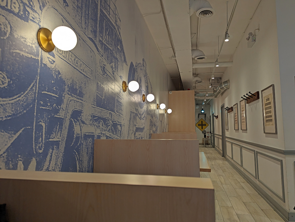 inside Platform Espresso Bar with train mural and seating