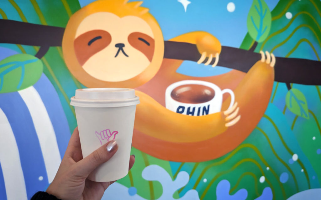 Cup and Mural at Phin Coffee Bar