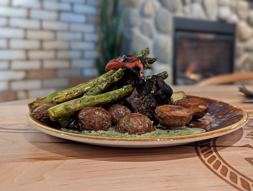 Steak stacked with asparagus and surrounded with roasted potatoes at Hook Line & Sinker restaurant in Haliburton