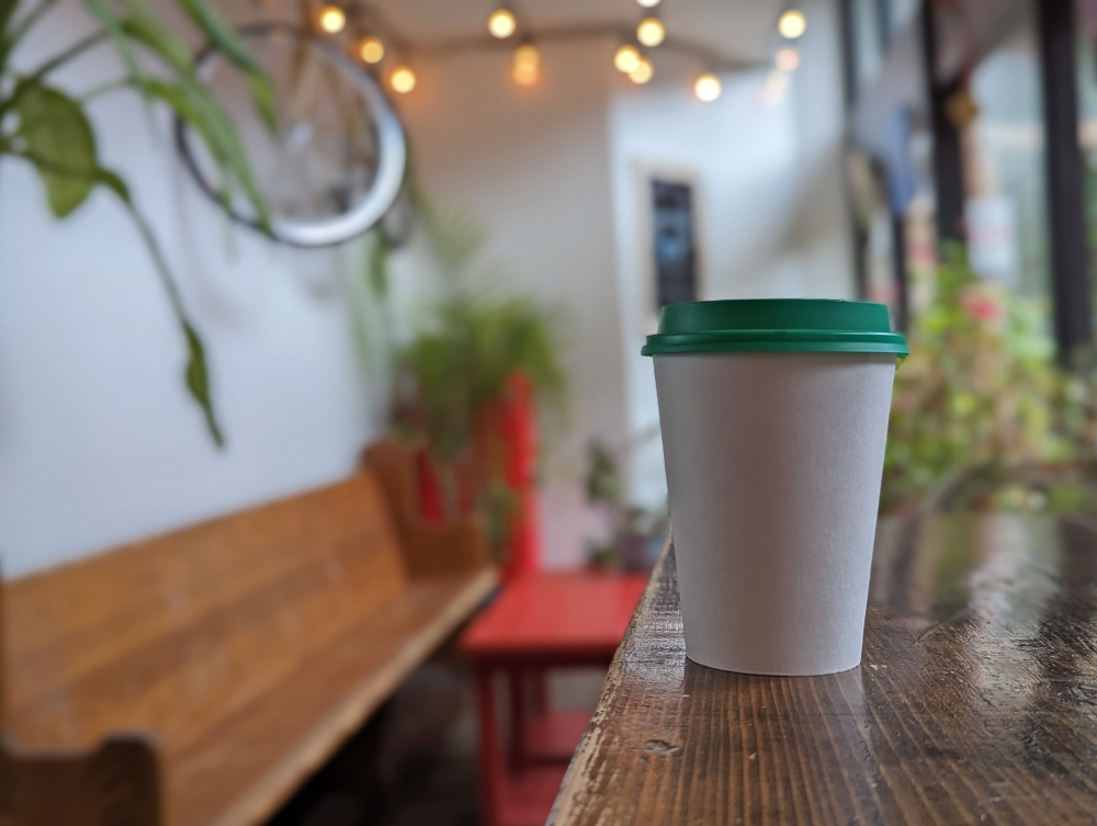 coffee cup sitting on a shelf at Kuppajo Espresso Bar