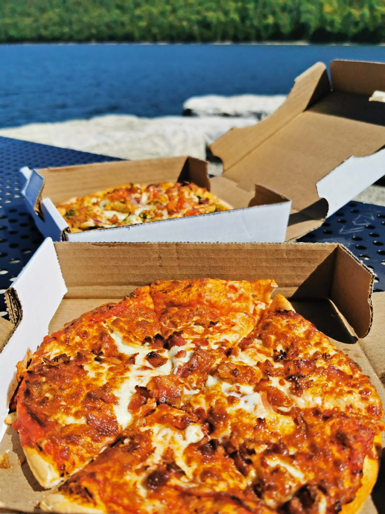 takeout pizzas from Buoy's Eatery, eating on the pier