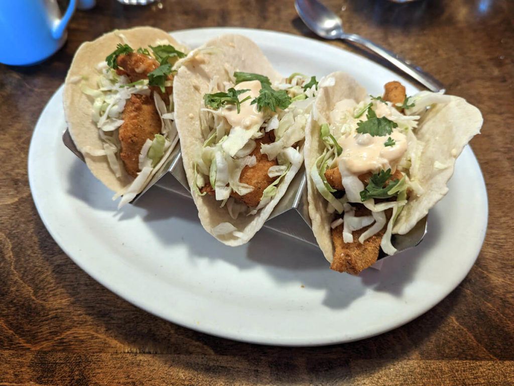 Three Tacos with Fried Fish topped with Greens and Sauce from Elliott's Restaurant in Little Current